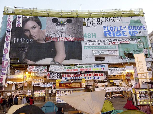Spain protests: banners hang from a building