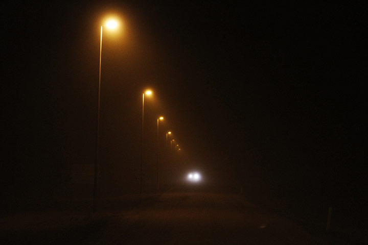 iceland volcano: A car travels down a highway 