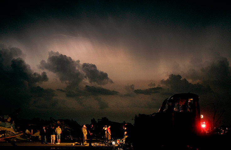 US tornado: Emergency workers wait after finding a body in a car in Joplin