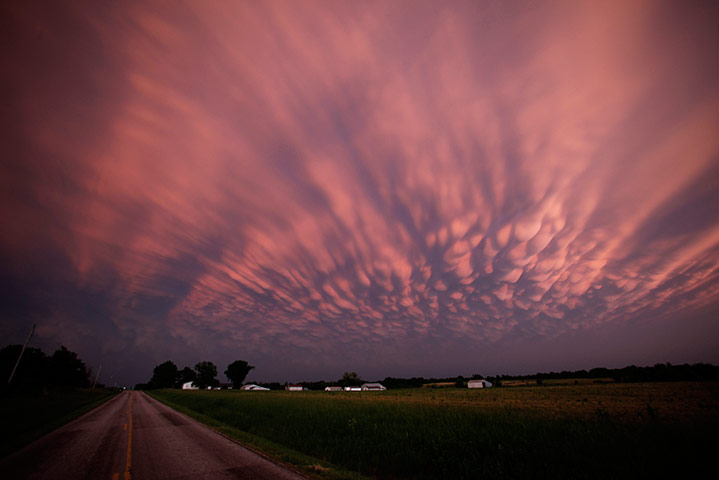 US tornado: Storm clouds dwarf a farm near Lamar, Missouri