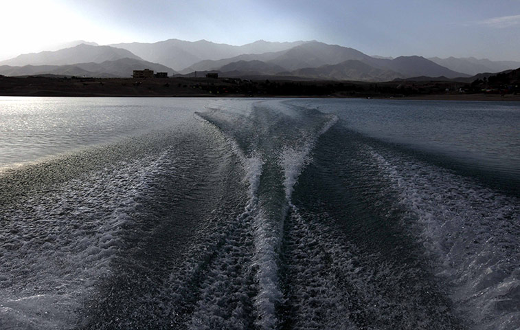 24 hours: Kabul, Afghanistan: Ripples are created from a motorboat on Qargha Lake 
