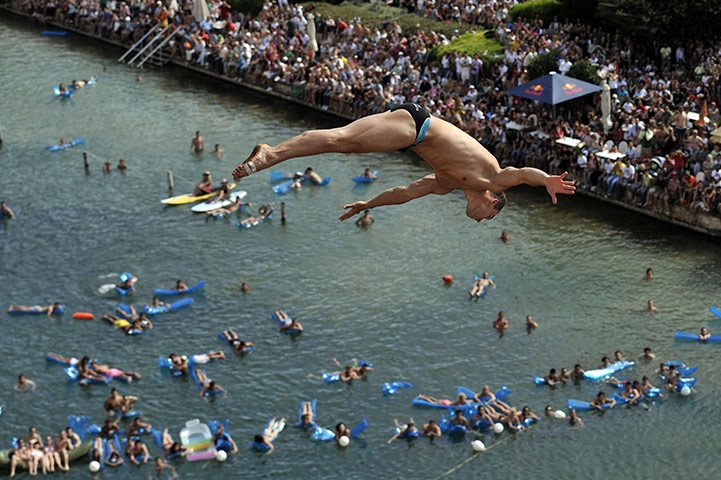 24 hours: Athens, Greece: An athlete dives during the Red Bull Cliff Diving Series