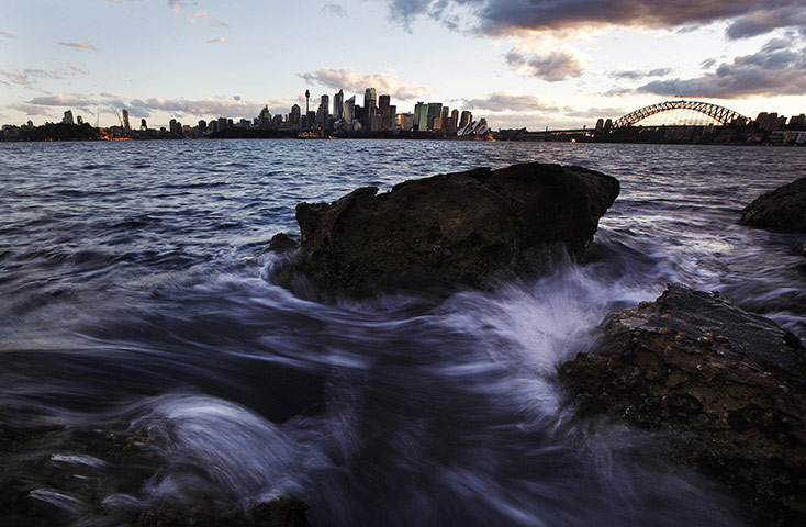 24 hours: Sydney, Australia: Small waves crash over rocks across the harbour 