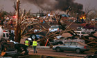 Rescue workers walk through an area of Joplin, Missouri, hit by the tornado