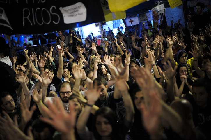 Spain protests continue: Demonstrators observe a minute of silence at the Sol Square Camp