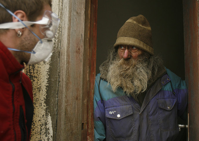 Grimsvotn volcano: A member of a rescue team checks on a farmer near to Kirkjubaearklaustur