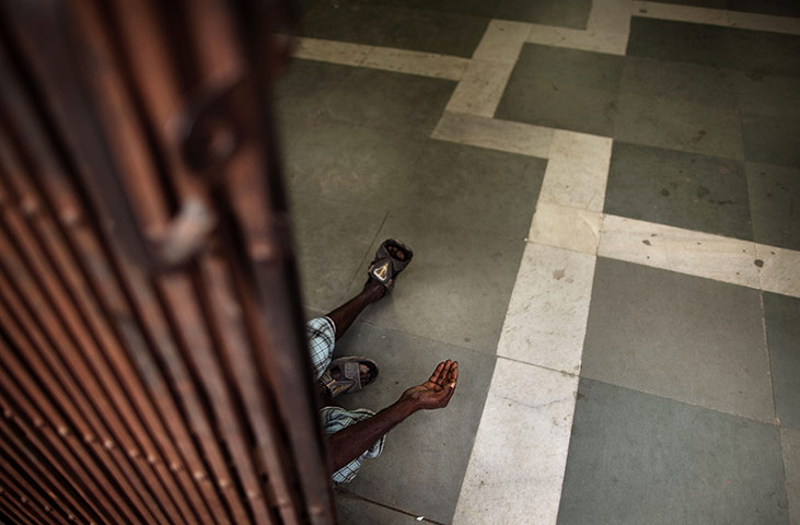 24 hours: New Delhi, India: An Indian man holds his hand out as he begs 