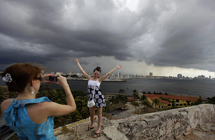 24 hours: Havana, Cuba: A tourist poses for a photograph at the El Morro fort