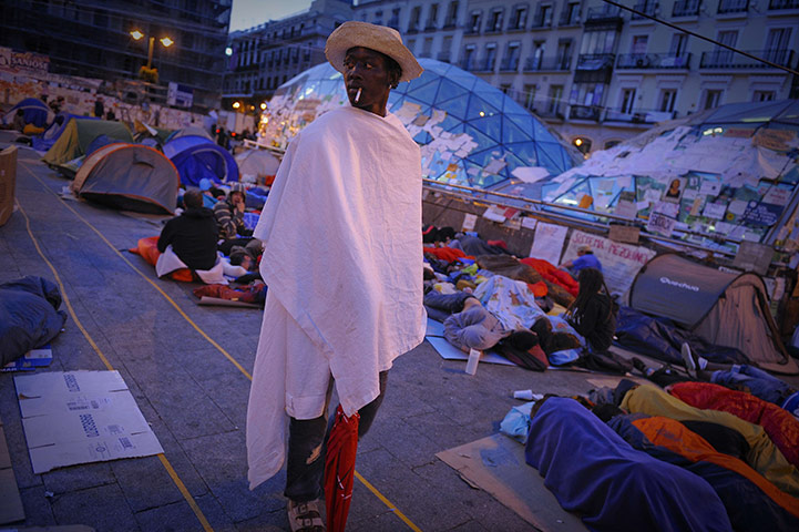 24 hours: Madrid, Spain: A man stands among protesters 