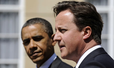Barack Obama listens asDavid Cameron speaks during a joint press conference at the Lancaster House