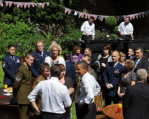 Obama UK visit update: Barack Obama and David Cameron speak with military personel in garden