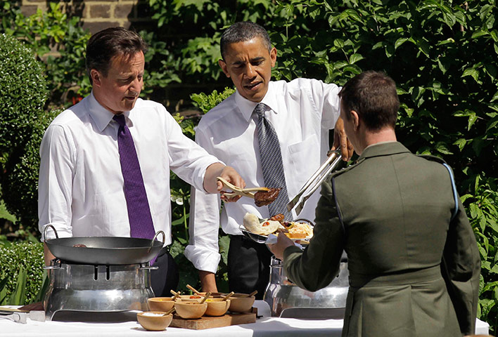 Obama UK visit update: David Cameron and Barack Obama serve food to a member of the military
