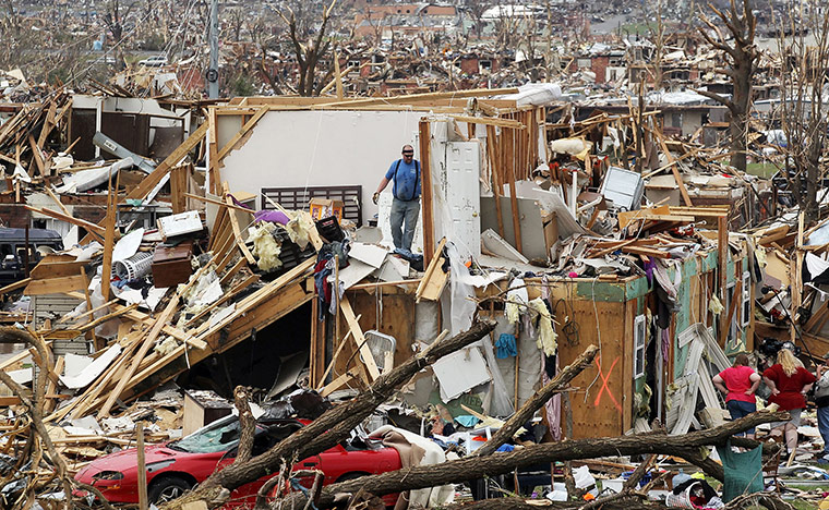 Tornadoes in US: People try to salvage items from a home after it was destroyed in Joplin