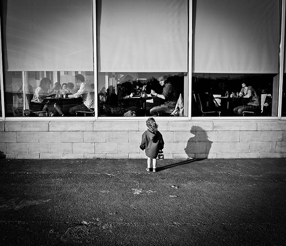 In pictures: expectation: girl looking in restaurant window