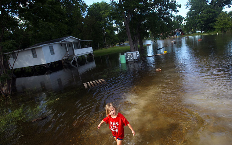 FTA Mario Tama: A girl walks through the floodwaters from the Atchafalaya River Simmesport