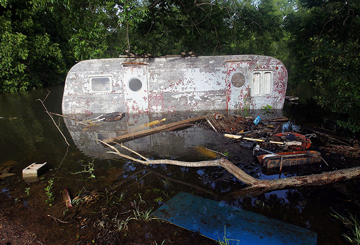 FTA Mario Tama: An old mobile home is partially submerged in the floodwater