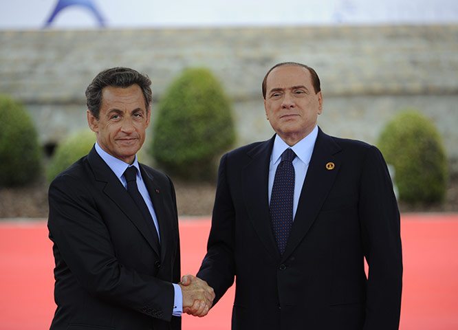 G8 summit: Nicolas Sarkozy shakes hands with Italian Prime Minister Silvio Berlusconi