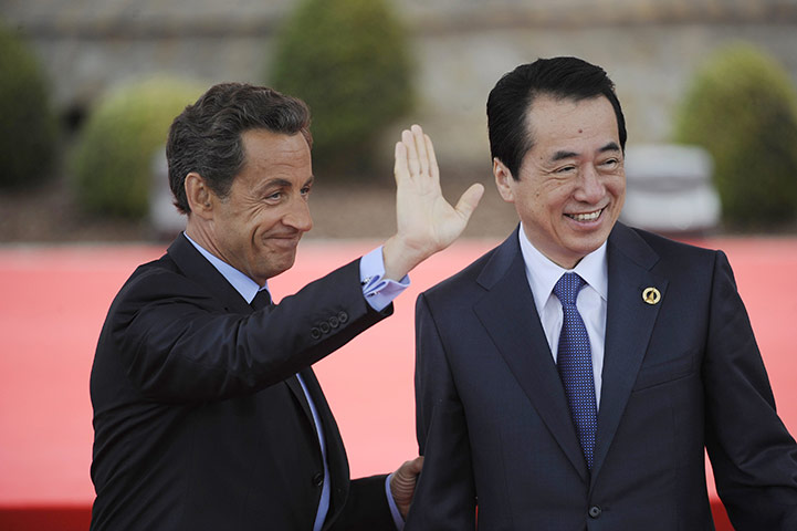 G8 summit: France's President Nicolas Sarkozy waves as he greets Japan's PM Naoto Kan