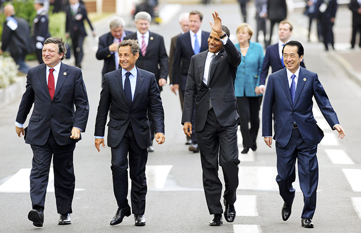 G8 summit: U.S. President Obama waves as he walks with world leaders 