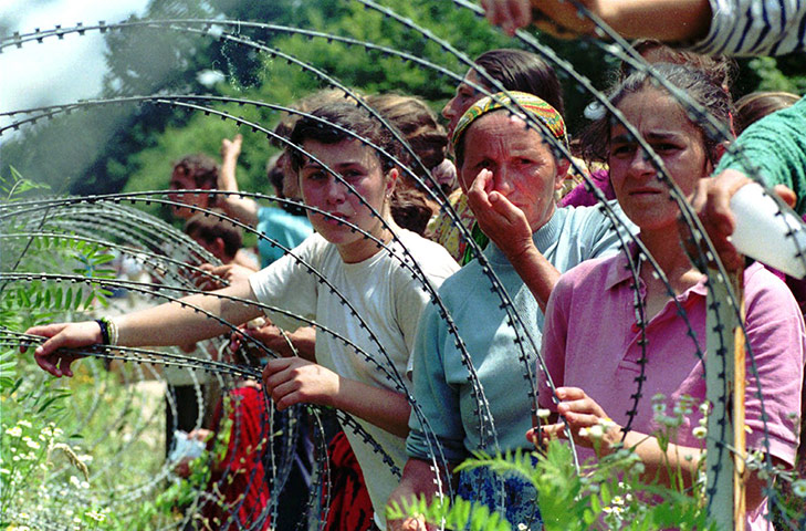 Ratko Mladic: Refugees from Srebrenica looking through the razorwire at arriving refugees