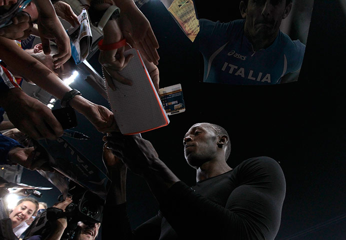 24 hours in pictures: Usain Bolt of Jamaica signs autographs in Rome