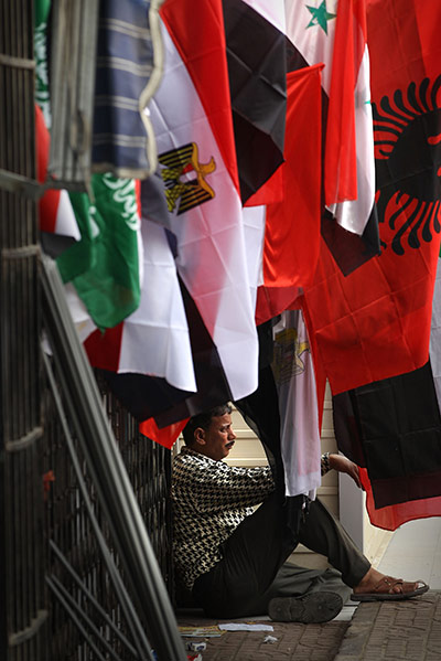 Middle East Unrest: A flag seller sits in Tahrir Square