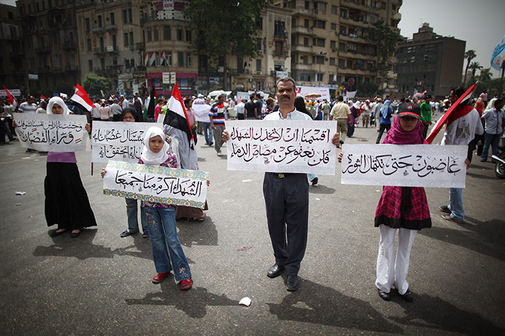 Middle East Unrest: A man and his family hold placards