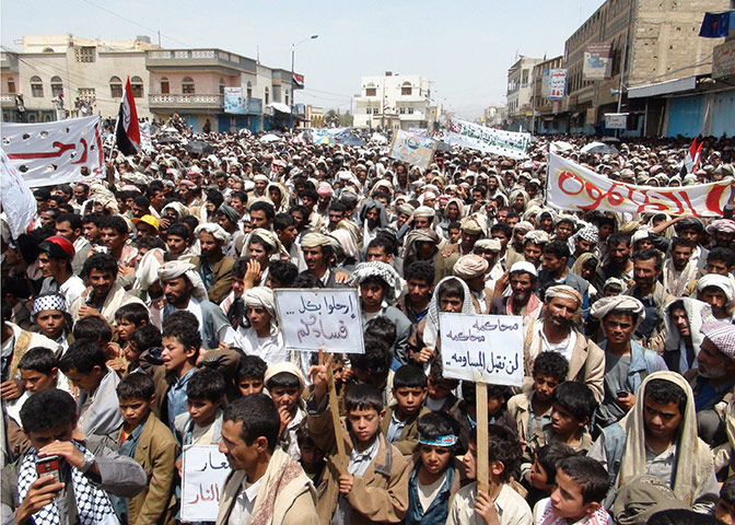 Middle East Unrest: Residents of a northern Yemeni province hold placards
