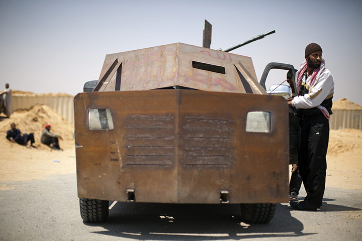 24 Hours: A rebel fighter next to a converted pick up truck in Misrata