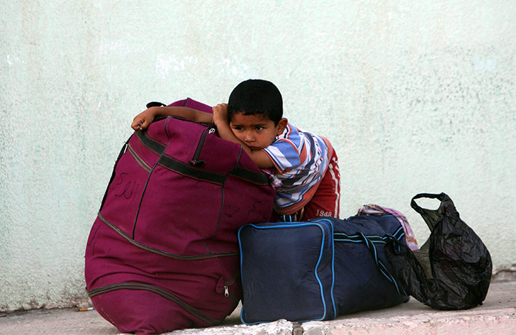 Egypt Gaza border: A Palestinian boy waits to cross into Egypt