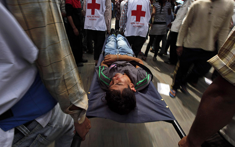 24 hours: Katmandu, Nepal: Paramedics carry an injured person