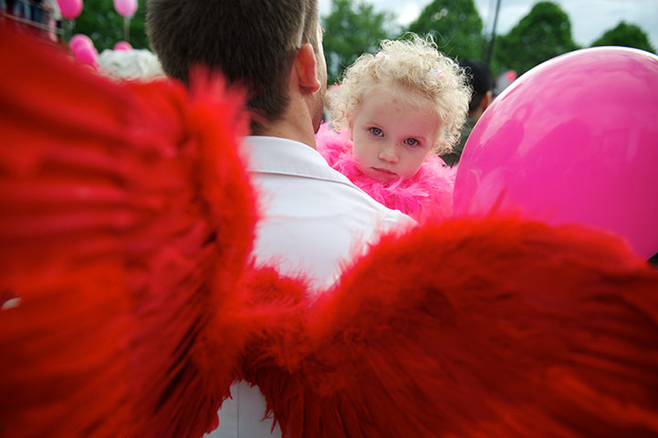 24 hours: Riga, Latvia: A man and his daughter participate in a Go Blonde parade