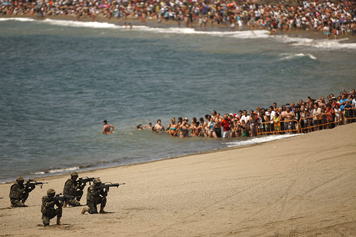 24 hours: Malaga, Spain: Spectators watch Marine infantry brigade simulate an assault