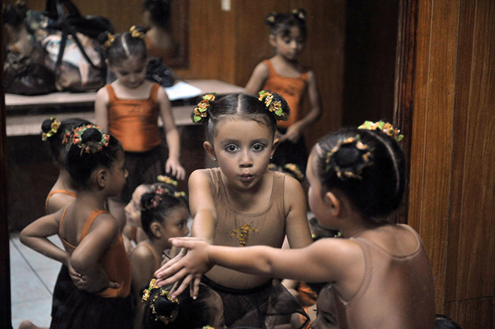 24 hours in pictures: A student of Marcelle Bomge National School of Dance looks in the mirror
