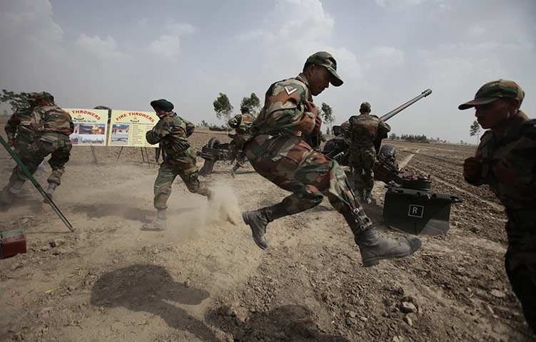 24 hours in pictures: Army personnel jump uring Indian army's war exercise