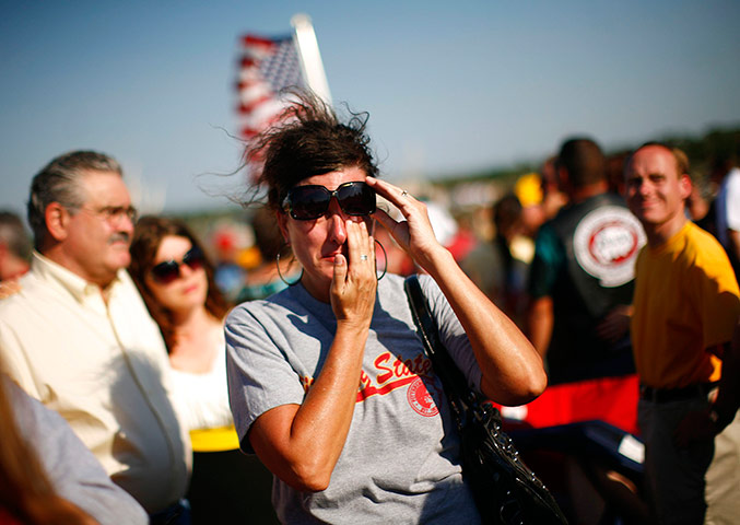 24 hours in pictures: People attend a ceremony marking a week since a tornado hit Joplin