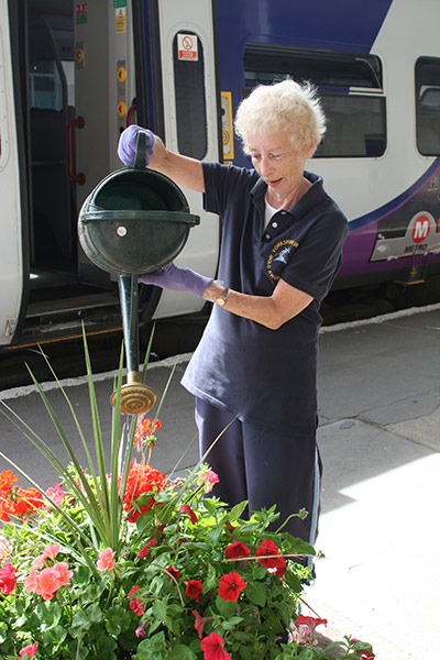 Community Railways: Watering flowers at a railway station