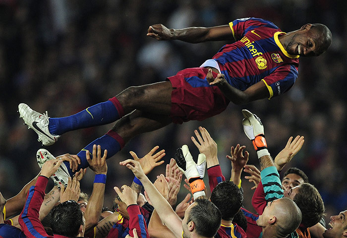 Barcelona v Real Madrid: Eric Abidal is thrown into the air by celebrating Barcelona players