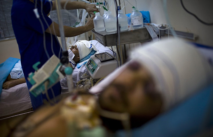 24 hours in pictures: Injured people lie in an intensive care until at Hikma hospital in Misrata