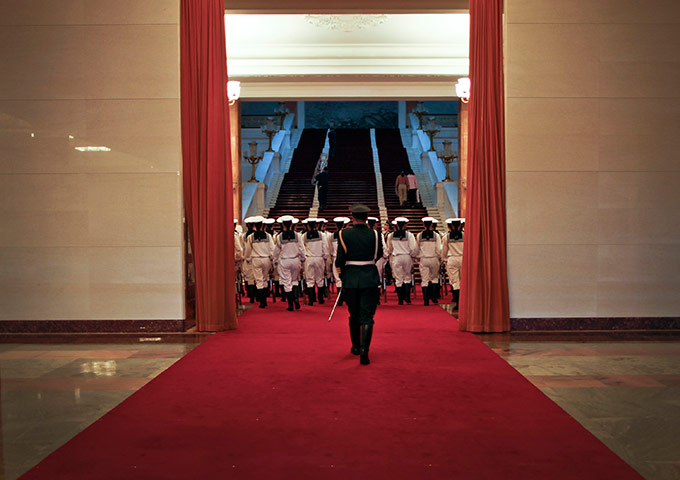24 hours in pictures: A military official walks into a hall with the guard of honour, China