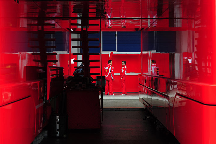 24 hours in pictures: Two Ferrari team members chat in the paddock in Istanbul Park