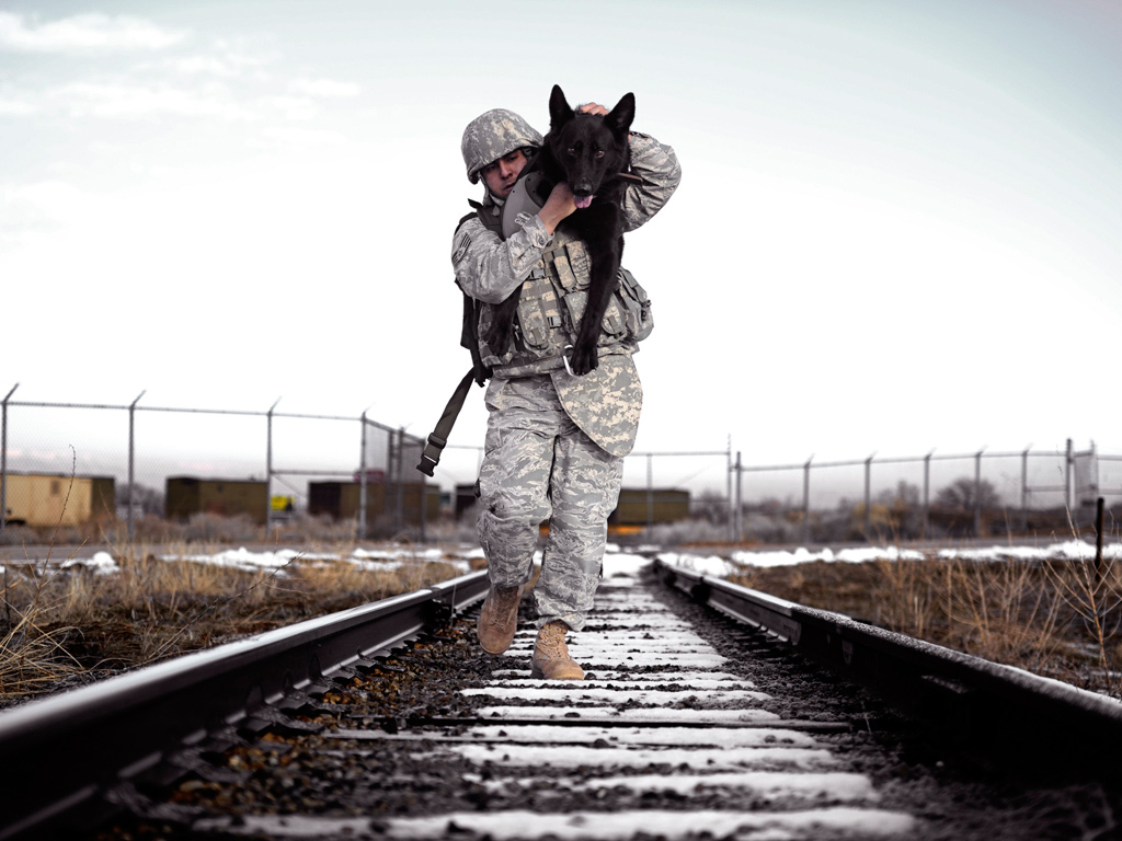 Staff Sgt. Erick Martinez using an over-the-shoulder carry with his military working dog in Utah