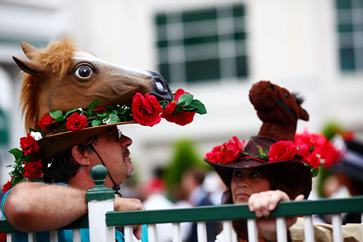 24 hours in pictures: Two racing fans display their hats at Kentucky Derby in Louisville