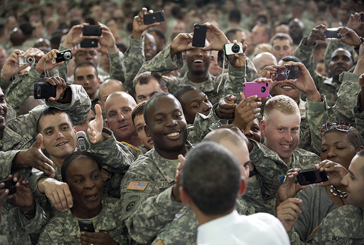 24 hours in pictures: resident Barack Obama shakes hands with troops at Fort Campbell, Kentucky