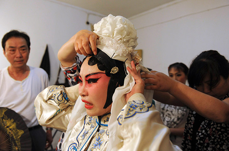 24 hours in pictures: Student cries and sweats as she is helped off with her headwear, China