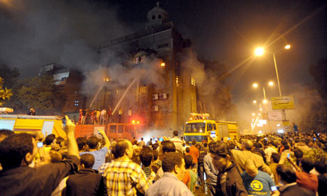 Egyptians gather outside a burning church in Cairo