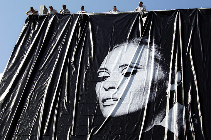 24 hours in pictures: Cannes, France: Workers set up a giant canvas at 64th Cannes Film Festival 
