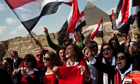 Egyptian tour guides wave national flag