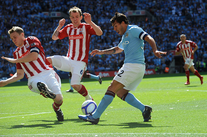 Top 50 transfer targets: Carlos Tevez crosses past Shawcross and Whelan during the FA Cup final