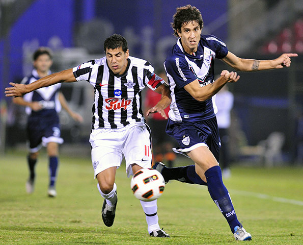 Top 50 transfer targets: Velez Sarsfield's Ricardo Alvarez, right, and Libertad's Carlos Bonet